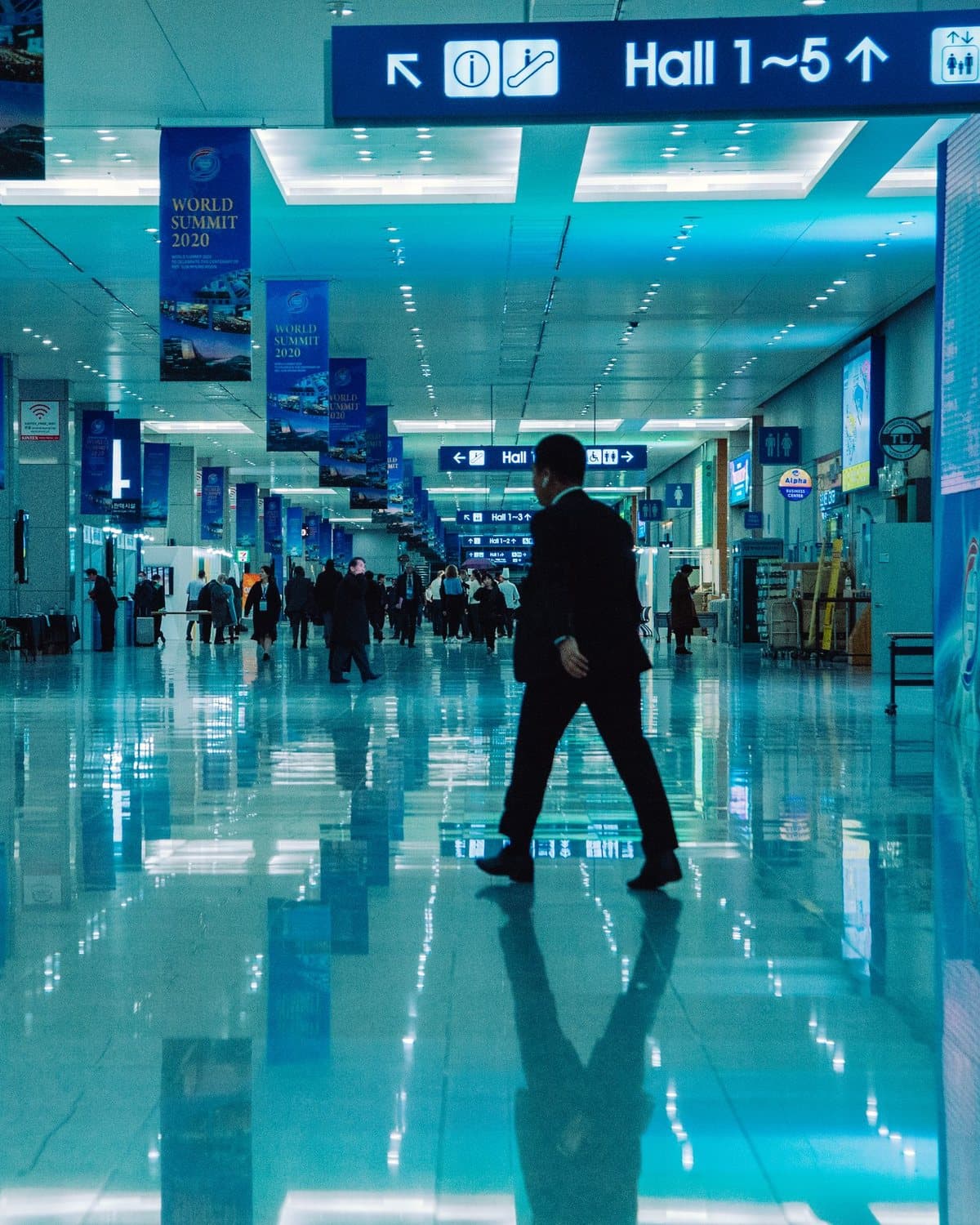 Visitors walking through an exhibition centre hall